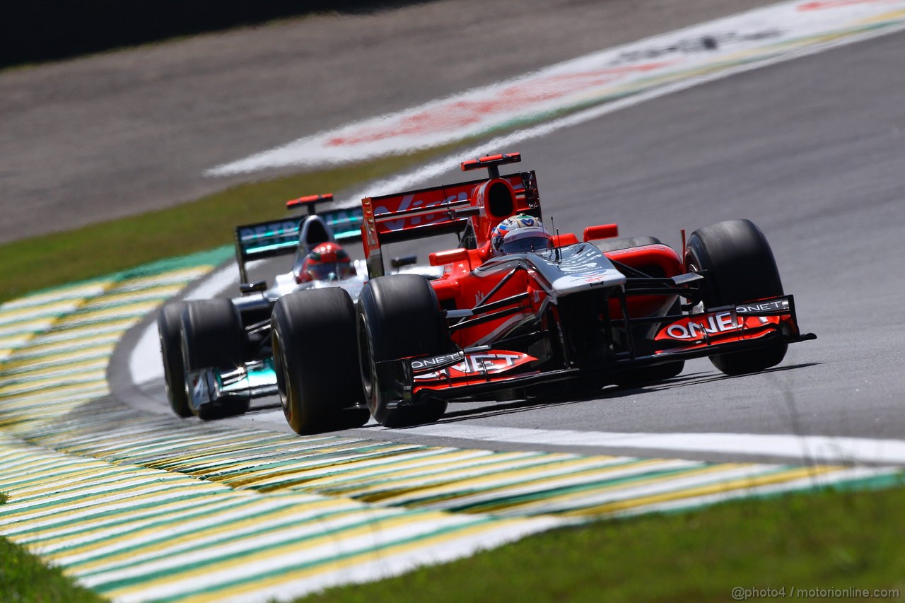 GP BRASILE, 25.11.2011- Prove Libere 1, Venerdi', Timo Glock (GER), Marussia Virgin Racing VR-02 e Michael Schumacher (GER), Mercedes GP Petronas F1 Team, MGP W02 