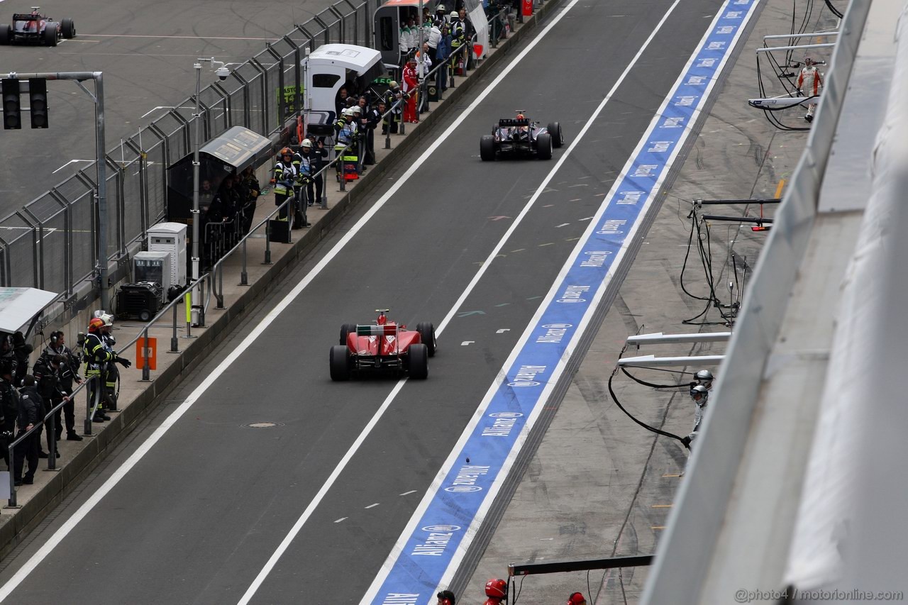 GP GERMANIA, 24.07.2011- Gara, Sebastian Vettel (GER), Red Bull Racing, RB7 goes out from the Pit lane in front of Felipe Massa (BRA), Ferrari, F-150 Italia 