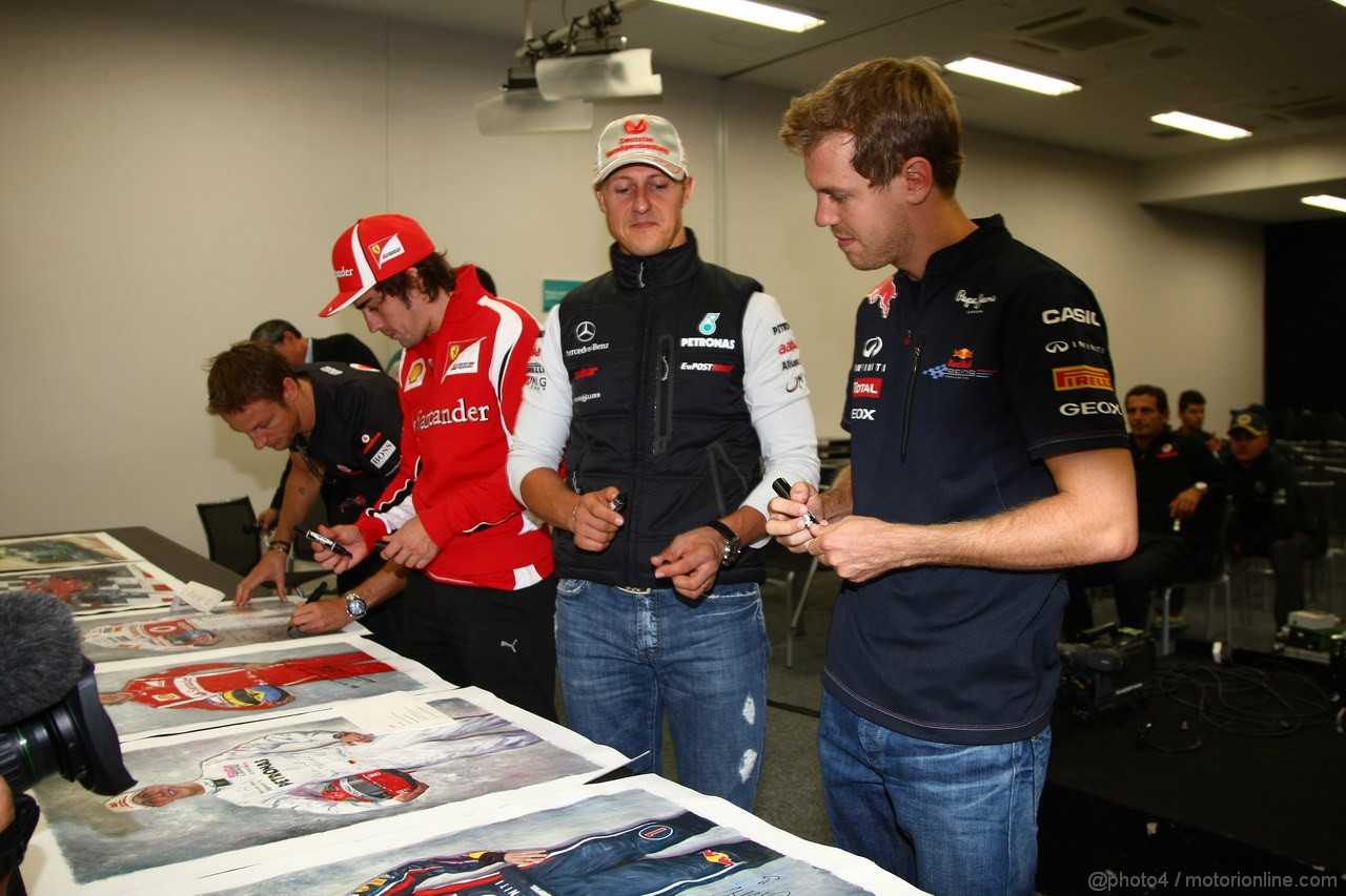 GP GIAPPONE, 07.10.2011- The 5 world champions with signed photos commissioned by Bernie Ecclestone (GBR) to then be put up for auction to raise money for the Japanese disaster, Jenson Button (GBR), McLaren  Mercedes, MP4-26, Fernando Alonso (ESP), Ferrari, F-150 Italia, Michael Schumacher (GER), Mercedes GP Petronas F1 Team, MGP W02, Sebastian Vettel (GER), Red Bull Racing, RB7 
