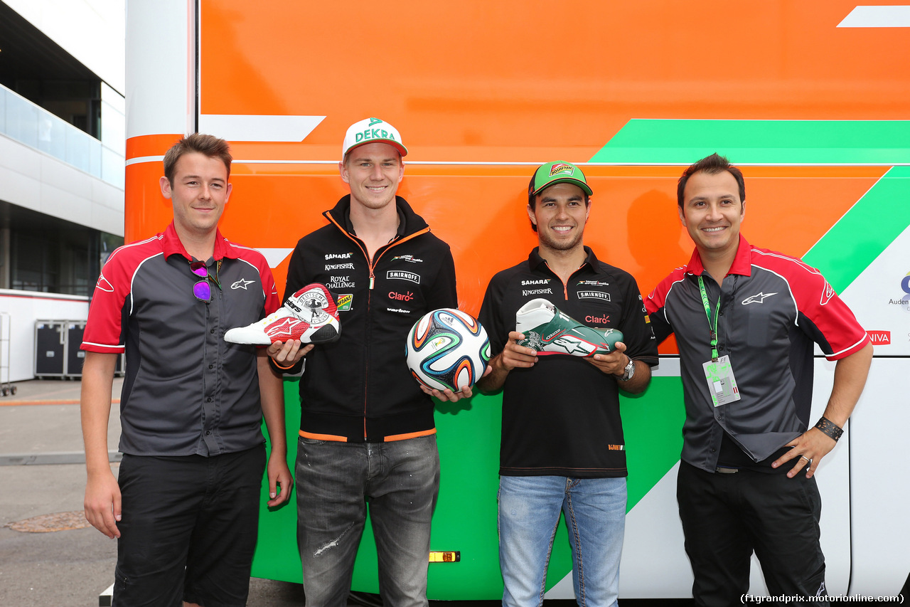 GP AUSTRIA, 19.06.2014- (L to R): Nico Hulkenberg (GER) Sahara Force India F1 e Sergio Perez (MEX) Sahara Force India F1 receive FIFA World Cup themed Alpinestars racing boots