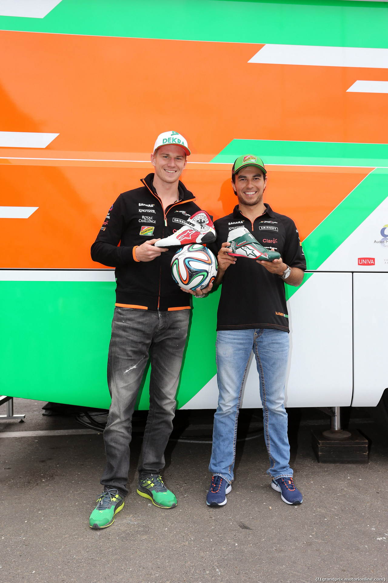 GP AUSTRIA, 19.06.2014- (L to R): Nico Hulkenberg (GER) Sahara Force India F1 e Sergio Perez (MEX) Sahara Force India F1 receive FIFA World Cup themed Alpinestars racing boots