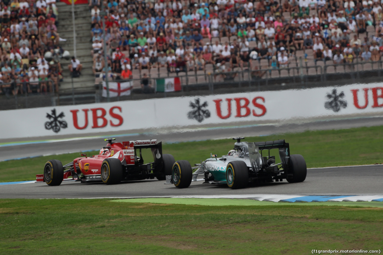 GP GERMANIA, 20.07.2014- Gara, the fight btween Kimi Raikkonen (FIN) Ferrari F14T e Lewis Hamilton (GBR) Mercedes AMG F1 W05