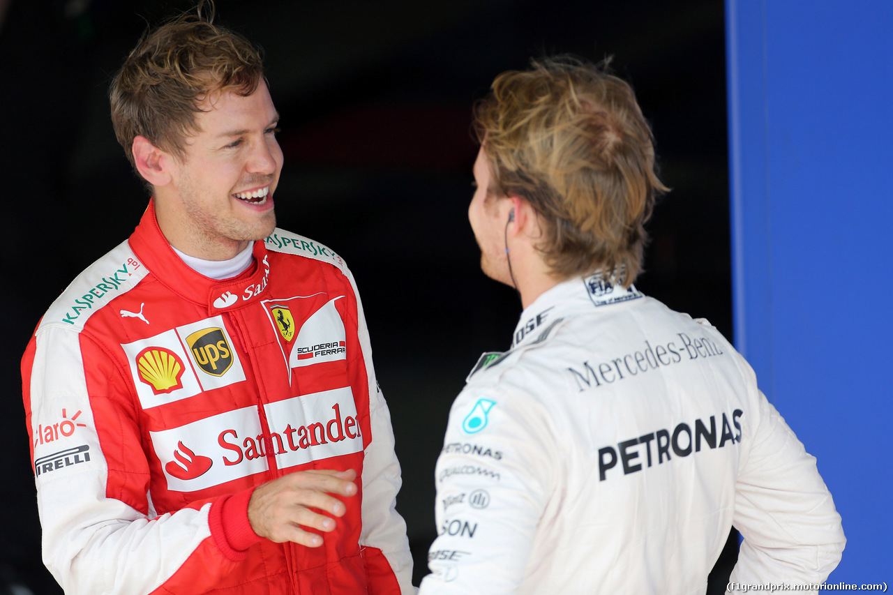 GP BRASILE, 14.11.2015 - Qualifiche, terzo Sebastian Vettel (GER) Ferrari SF15-T e Nico Rosberg (GER) Mercedes AMG F1 W06 pole position