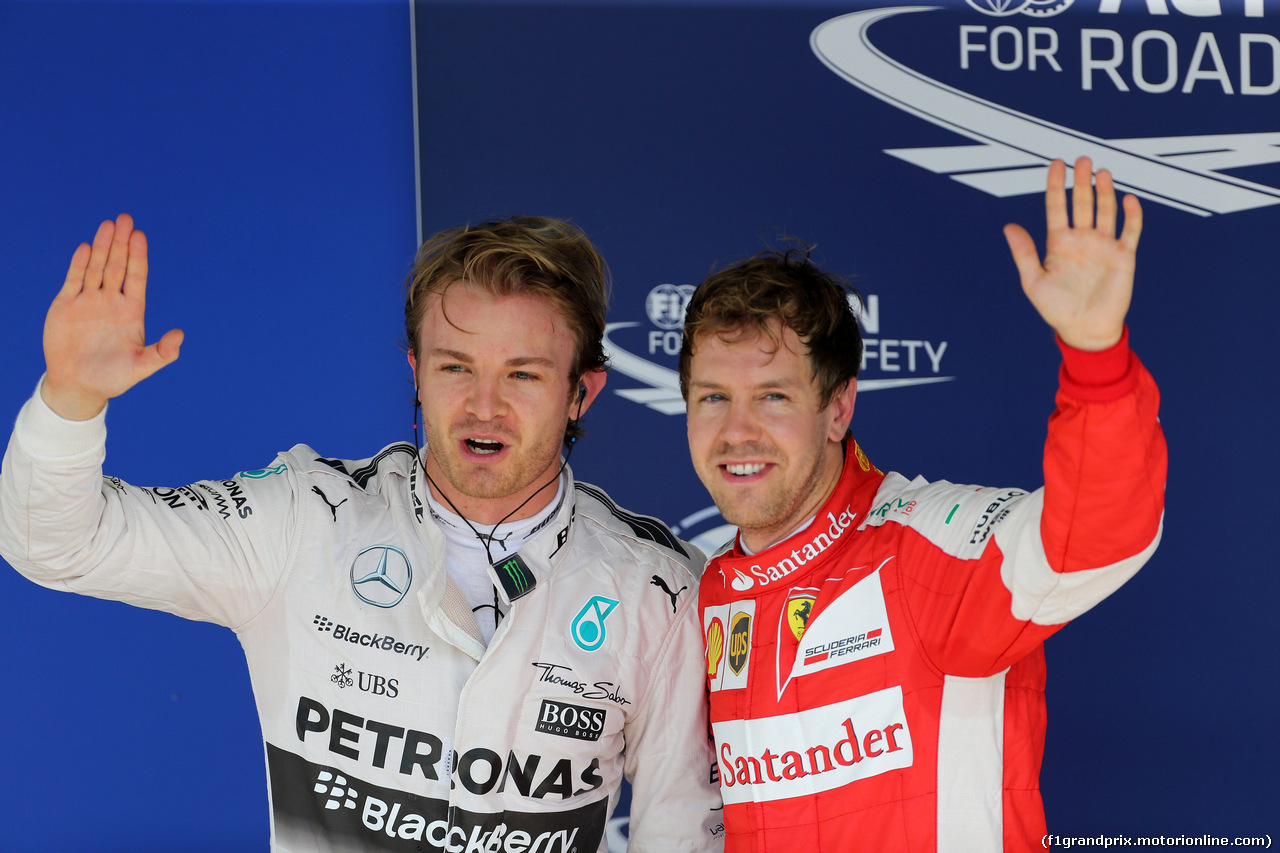 GP BRASILE, 14.11.2015 - Qualifiche, Nico Rosberg (GER) Mercedes AMG F1 W06 pole position e terzo Sebastian Vettel (GER) Ferrari SF15-T