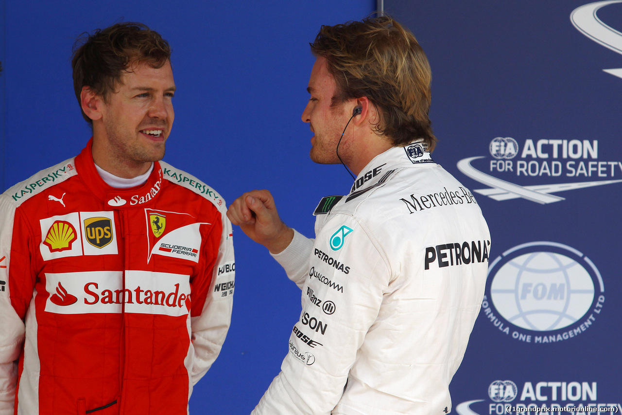 GP BRASILE, 14.11.2015 - Qualifiche, terzo Sebastian Vettel (GER) Ferrari SF15-T e Nico Rosberg (GER) Mercedes AMG F1 W06 pole position