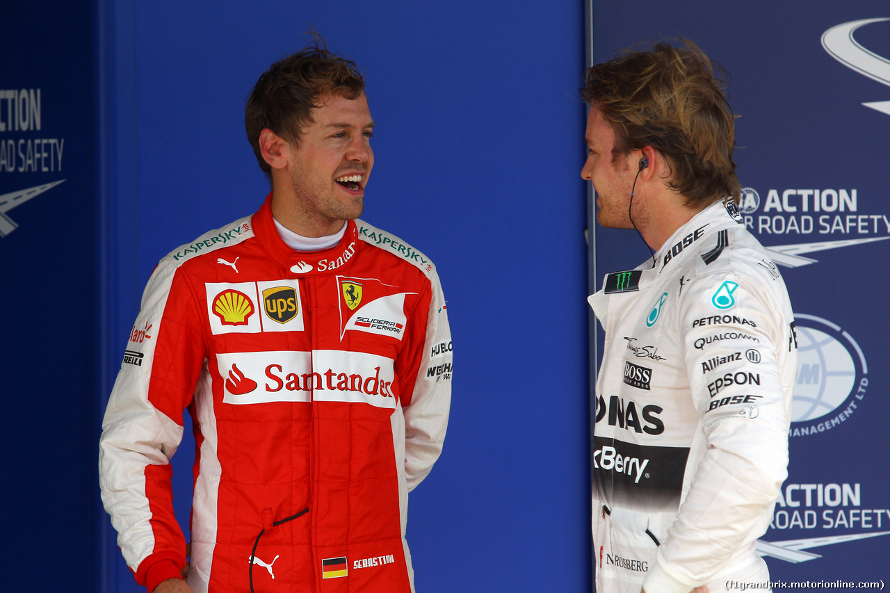 GP BRASILE, 14.11.2015 - Qualifiche, terzo Sebastian Vettel (GER) Ferrari SF15-T e Nico Rosberg (GER) Mercedes AMG F1 W06 pole position