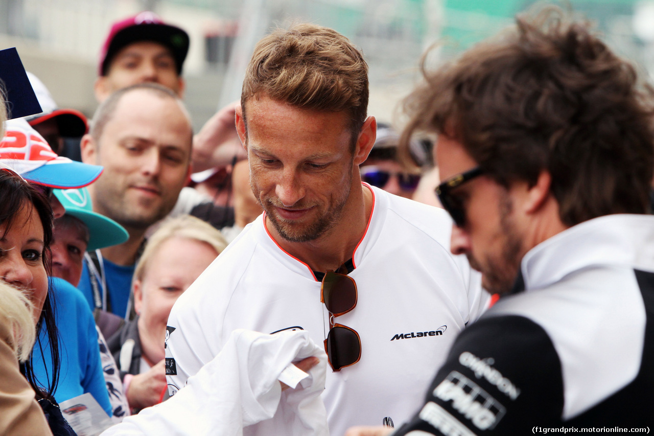 GP GRAN BRETAGNA, 07.07.2016- (L to R): Jenson Button (GBR) McLaren e team mate Fernando Alonso (ESP) McLaren sign autographs for the fans.