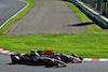 GP GIAPPONE, Sergio Perez (MEX) Red Bull Racing RB19 e Zhou Guanyu (CHN) Alfa Romeo F1 Team C43 battle for position.
24.09.2023. Formula 1 World Championship, Rd 17, Japanese Grand Prix, Suzuka, Japan, Gara Day.
 - www.xpbimages.com, EMail: requests@xpbimages.com © Copyright: Coates / XPB Images