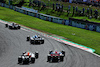 GP GIAPPONE, Sergio Perez (MEX) Red Bull Racing RB19 e Zhou Guanyu (CHN) Alfa Romeo F1 Team C43 battle for position.
24.09.2023. Formula 1 World Championship, Rd 17, Japanese Grand Prix, Suzuka, Japan, Gara Day.
 - www.xpbimages.com, EMail: requests@xpbimages.com © Copyright: Coates / XPB Images