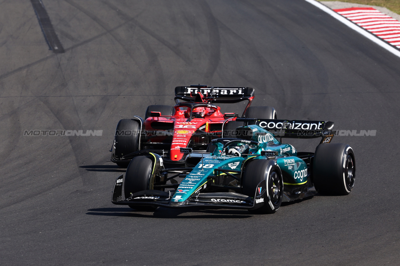 GP UNGHERIA, Lance Stroll (CDN) Aston Martin F1 Team AMR23 e Charles Leclerc (MON) Ferrari SF-23 battle for position.

23.07.2023. Formula 1 World Championship, Rd 12, Hungarian Grand Prix, Budapest, Hungary, Gara Day.

- www.xpbimages.com, EMail: requests@xpbimages.com © Copyright: Charniaux / XPB Images