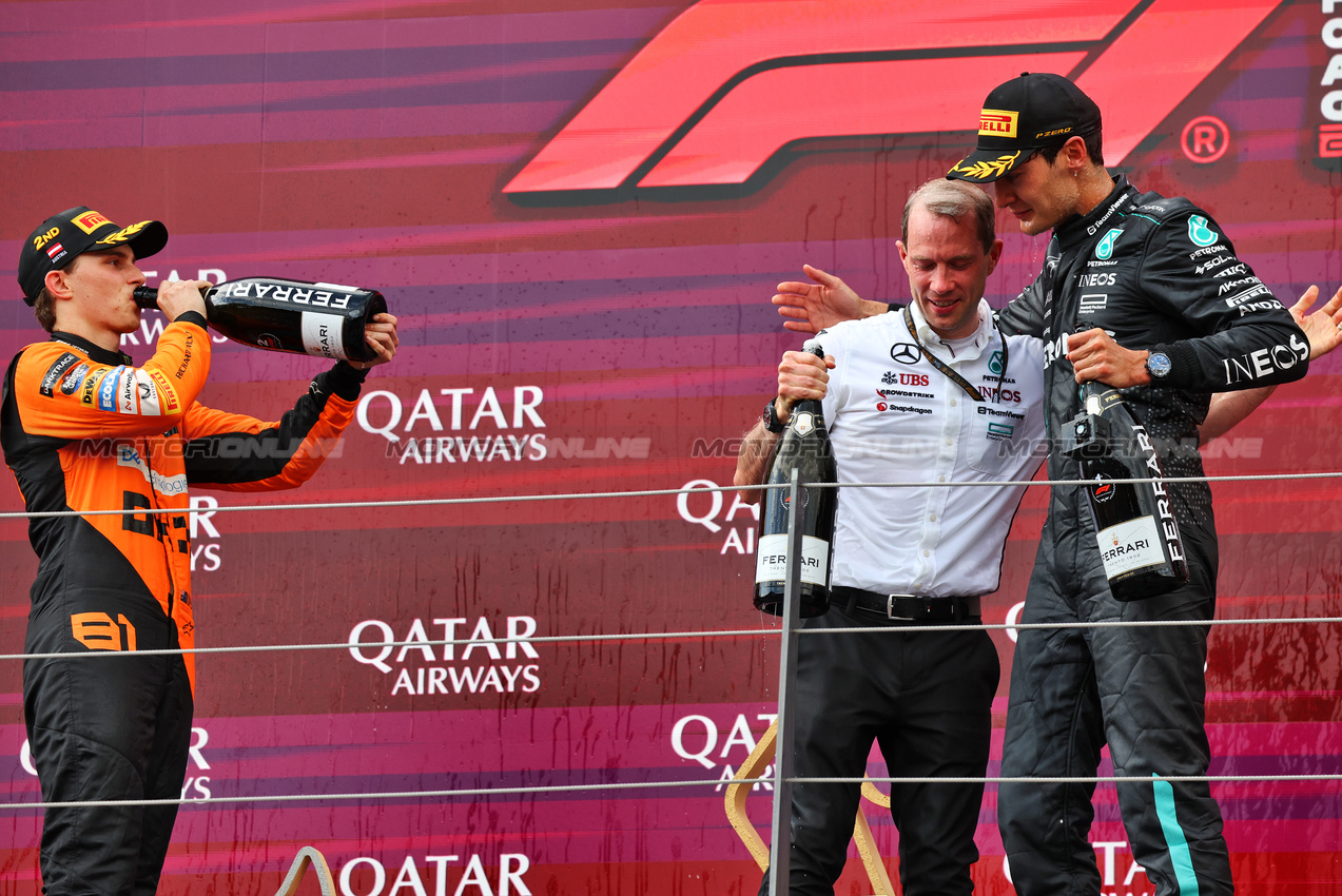 GP AUSTRIA, (L to R): Oscar Piastri (AUS) McLaren celebrates on the podium with Marcus Dudley (GBR) Mercedes AMG F1 Gara Engineer e vincitore George Russell (GBR) Mercedes AMG F1.

30.06.2024. Formula 1 World Championship, Rd 11, Austrian Grand Prix, Spielberg, Austria, Gara Day.

- www.xpbimages.com, EMail: requests@xpbimages.com © Copyright: Batchelor / XPB Images