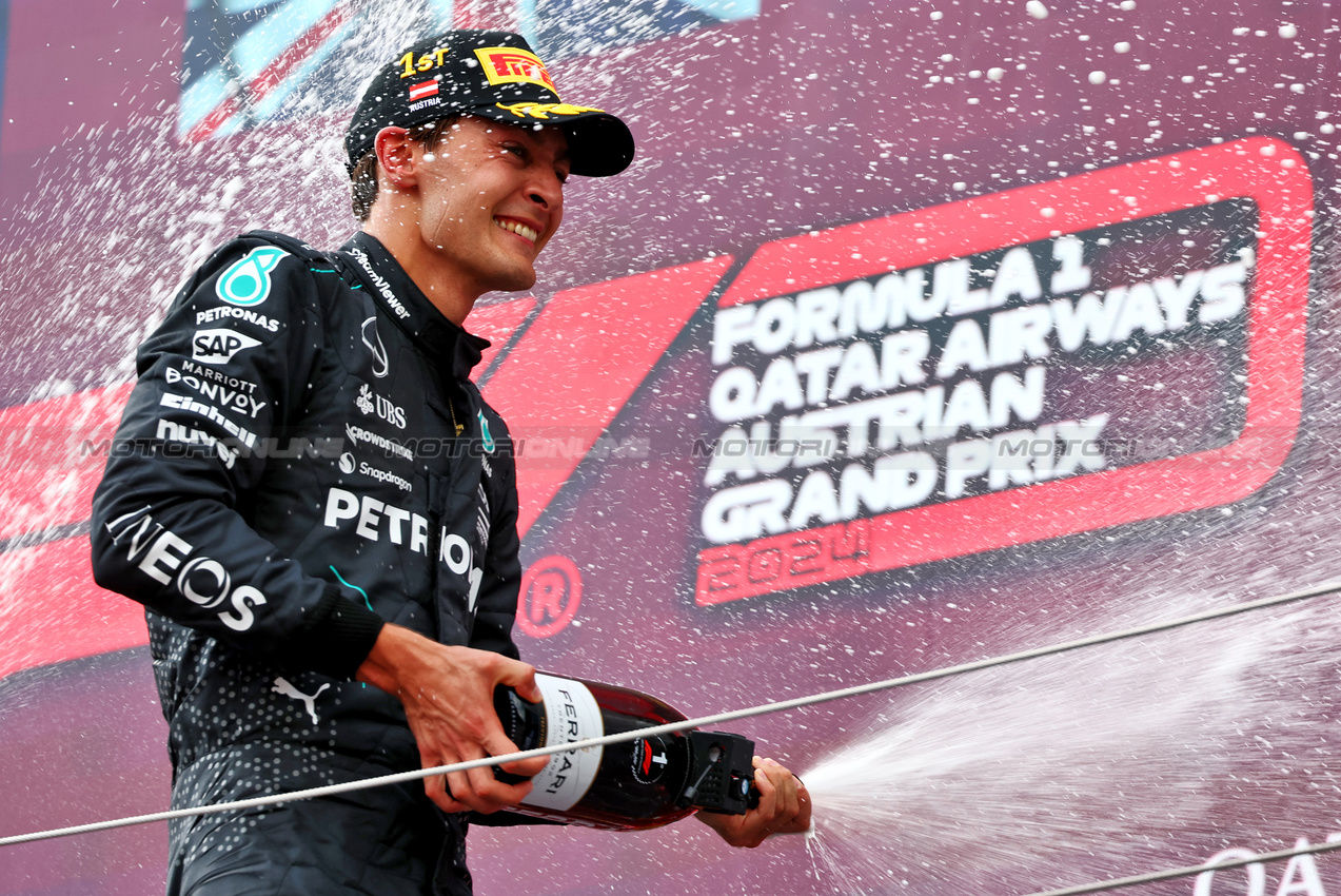 GP AUSTRIA, Gara winner George Russell (GBR) Mercedes AMG F1 celebrates on the podium.

30.06.2024. Formula 1 World Championship, Rd 11, Austrian Grand Prix, Spielberg, Austria, Gara Day.

 - www.xpbimages.com, EMail: requests@xpbimages.com © Copyright: Coates / XPB Images