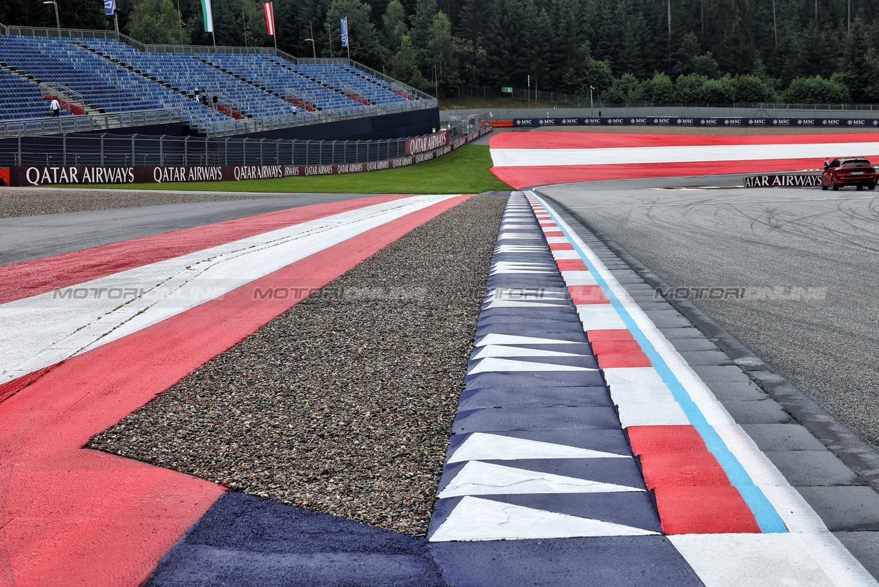 GP AUSTRIA, A gravel strip at the penultimate corner to deter track limit infractions.

27.06.2024. Formula 1 World Championship, Rd 11, Austrian Grand Prix, Spielberg, Austria, Preparation Day.

- www.xpbimages.com, EMail: requests@xpbimages.com © Copyright: Batchelor / XPB Images