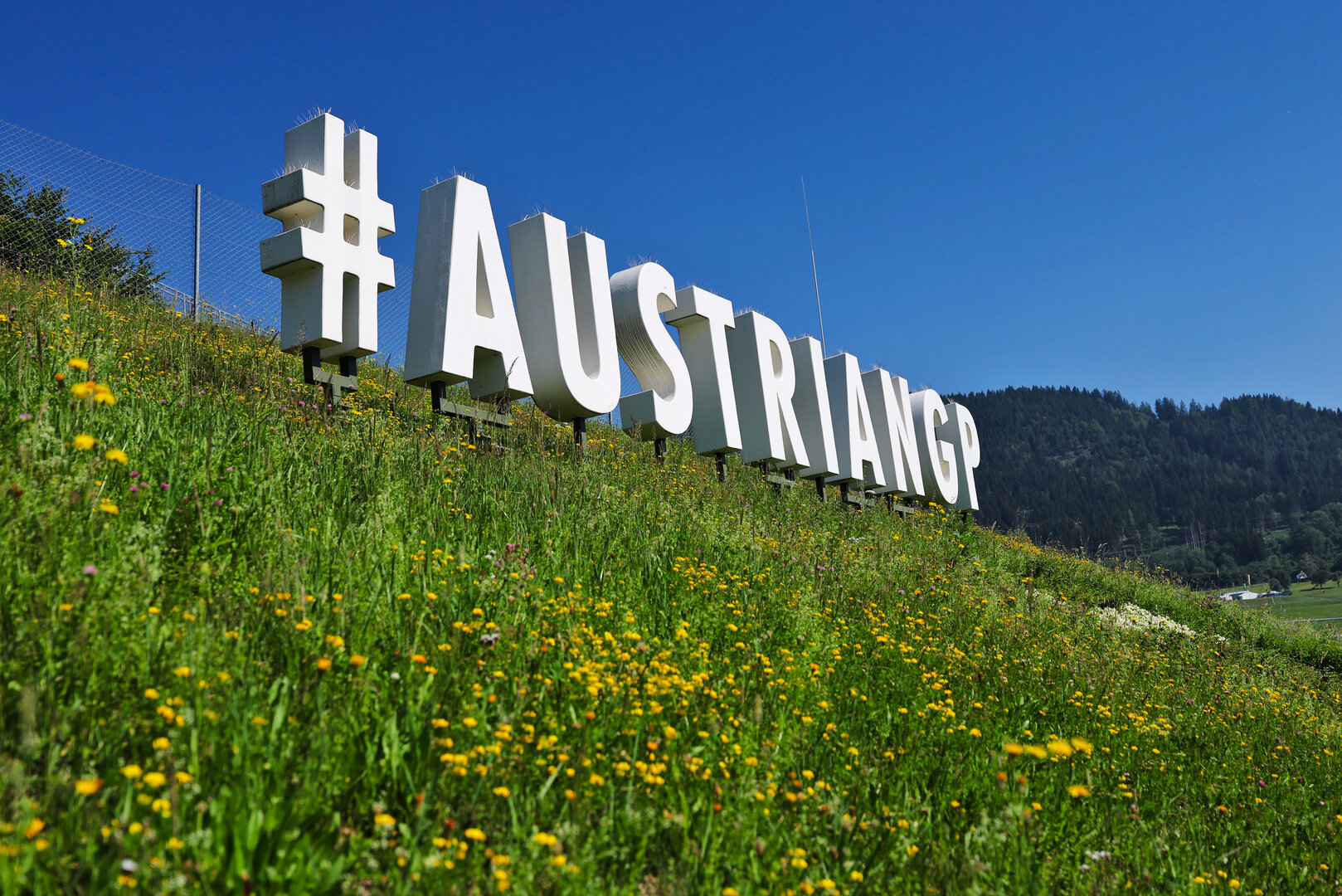 GP AUSTRIA, Circuit Atmosfera - #AustrianGP sign trackside.
25.06.2026. Formula 1 World Championship, Rd 8, Austrian Grand Prix, Spielberg, Austria, Preparation Day.
- www.xpbimages.com, EMail: requests@xpbimages.com © Copyright: Moy / XPB Images