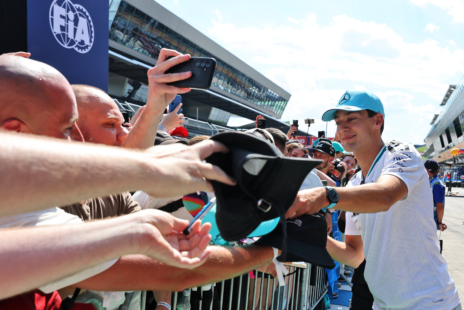 GP AUSTRIA, George Russell (GBR) Mercedes AMG Formula One Team with fans in the pits.
25.06.2026. Formula 1 World Championship, Rd 8, Austrian Grand Prix, Spielberg, Austria, Preparation Day.
- www.xpbimages.com, EMail: requests@xpbimages.com © Copyright: Moy / XPB Images
