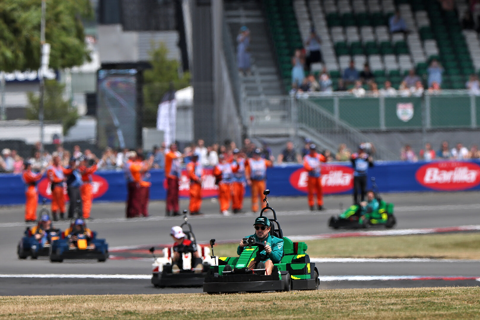 GP GRAN BRETAGNA, Fernando Alonso (ESP) Aston Martin F1 Team in a Lego kart on the drivers' parade. 
05.07.2026. Formula 1 World Championship, Rd 9, British Grand Prix, Silverstone, England, Gara Day.
- www.xpbimages.com, EMail: requests@xpbimages.com © Copyright: Charniaux / XPB Images