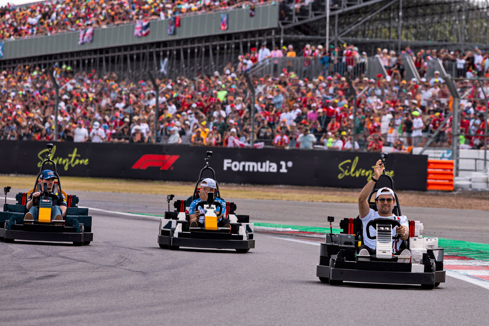 GP GRAN BRETAGNA, Sergio Perez (MEX) Cadillac Formula 1 Team in a Lego kart on the drivers' parade.
05.07.2026. Formula 1 World Championship, Rd 9, British Grand Prix, Silverstone, England, Gara Day.
 - www.xpbimages.com, EMail: requests@xpbimages.com © Copyright: Denny / XPB Images