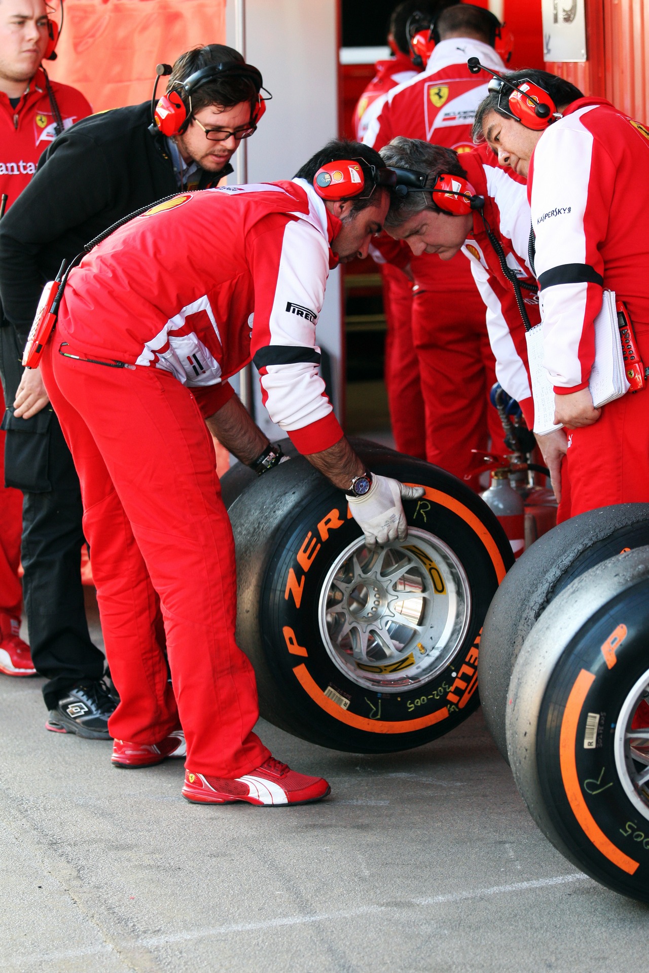 Ferrari check their Pirelli tyres.
