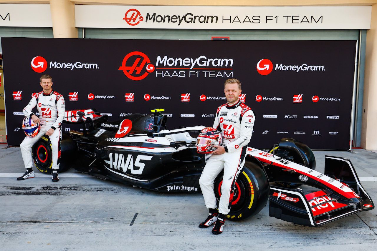 BAHRAIN INTERNATIONAL CIRCUIT, BAHRAIN - FEBRUARY 23: Nico Hulkenberg, Haas F1 Team, and Kevin Magnussen, Haas F1 Team,next to the Haas VF-23 during the Bahrain February Testing at Bahrain International Circuit on Thursday February 23, 2023 in Sakhir, Bahrain. (Photo by Sam Bloxham / LAT Images)