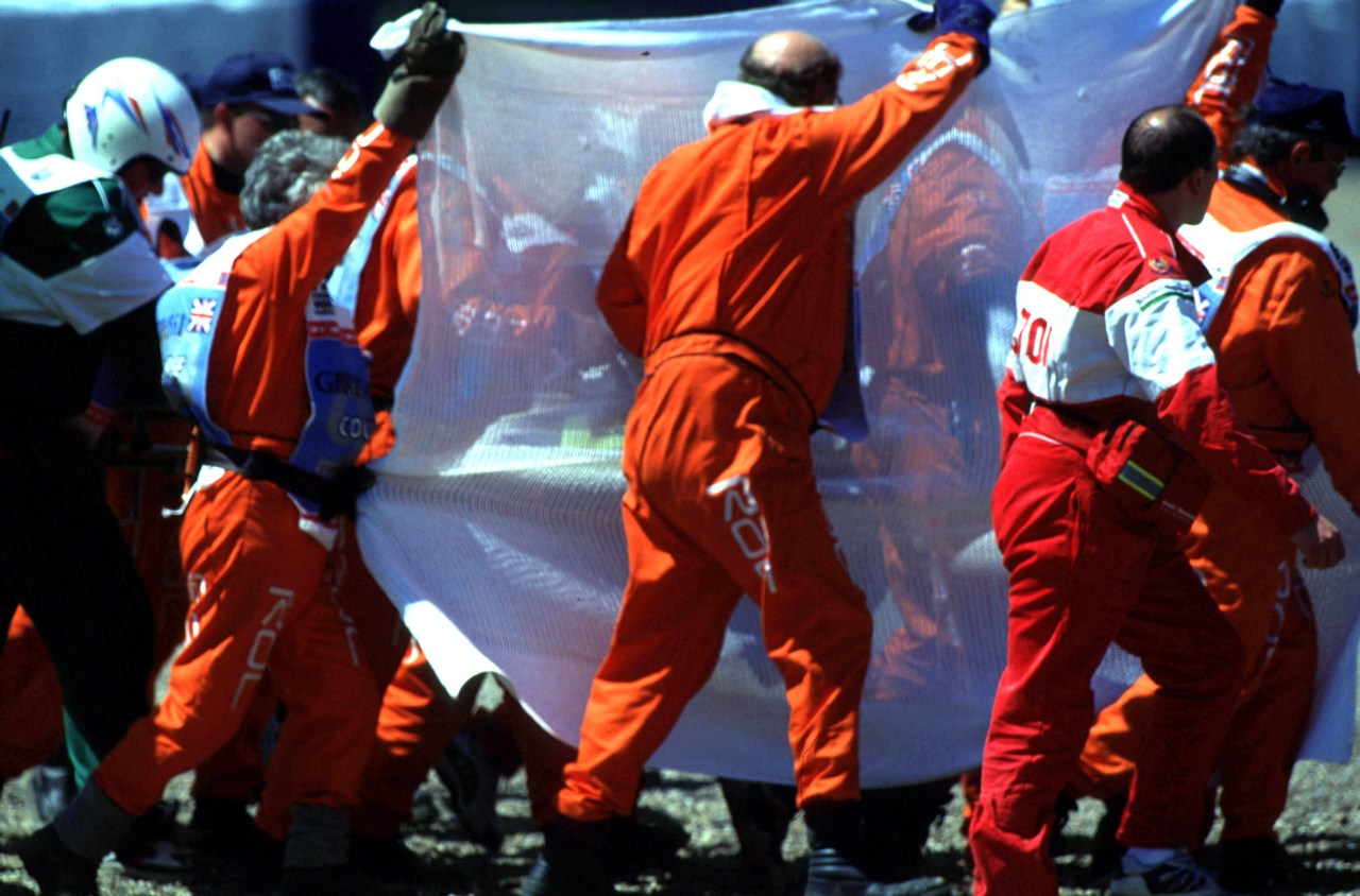 Formula One Championship 1999 - GP F1 Silverstone - Michael  lSchumacher (ger) iFerrari F399 iTeam Ferrari is shielded by Marshals as he is removed form his Ferrari, after htiing the tyre wall at over 100mph. Shumacher broke his leg in two places in the accident.
