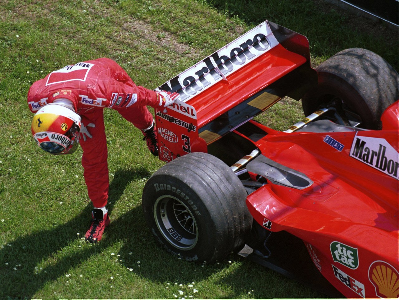 Formula One Championship 1999 - GP F1 Imola - Michae Schumacher
(ger) Ferrari F399- Team Ferrari F2008  checks his car after dropping out of practice for the San Marino Grand Prix.
