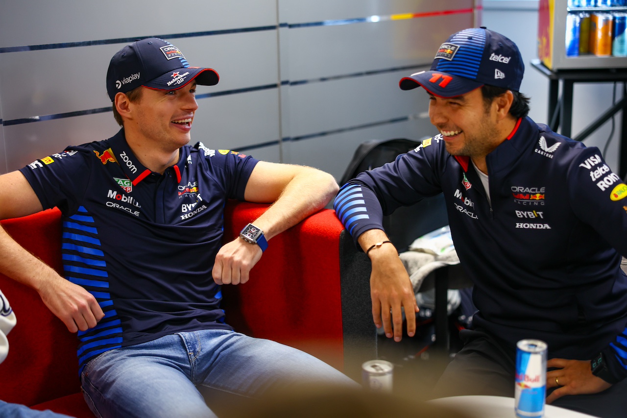 MILTON KEYNES, ENGLAND - FEBRUARY 15: Max Verstappen of the Netherlands and Oracle Red Bull Racing talks with Sergio Perez of Mexico and Oracle Red Bull Racing during the Oracle Red Bull Racing RB20 car launch at Red Bull Racing Factory on February 15, 2024 in Milton Keynes, England. (Photo by Mark Thompson/Getty Images for Red Bull Racing) // SI202402150743 // Usage for editorial use only // 